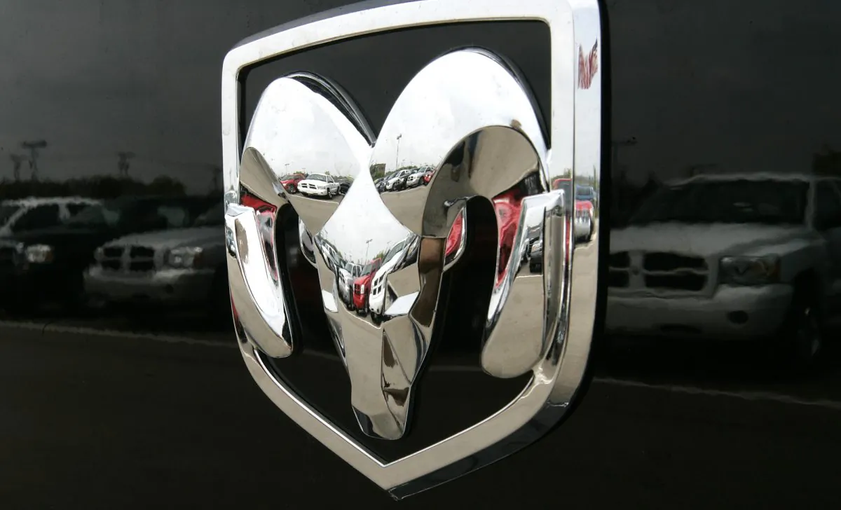 The Dodge logo on a Ram pickup truck at a dealership in Bloomfield Hills, Mich., on July 27, 2006. Fiat Chrysler is recalling about 67,000 model year 2006 and 2007 pickups because of a problem that could prevent the cars from starting, or cause them to move when the ignition key is turned. (AP Photo/Paul Sancya)