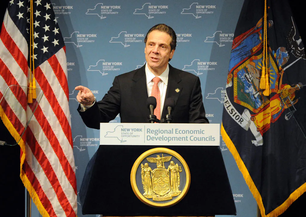 Gov. Andrew Cuomo during the Regional Economic Development Council Awards in Albany, N.Y., on Thursday, Dec. 11, 2014. New York officials said Monday that 13 more businesses have agreed to expand to or locate in tax-free zones at colleges and universities across the state while committing to bring new jobs. (AP Photo/Times Union, Michael P. Farrell)