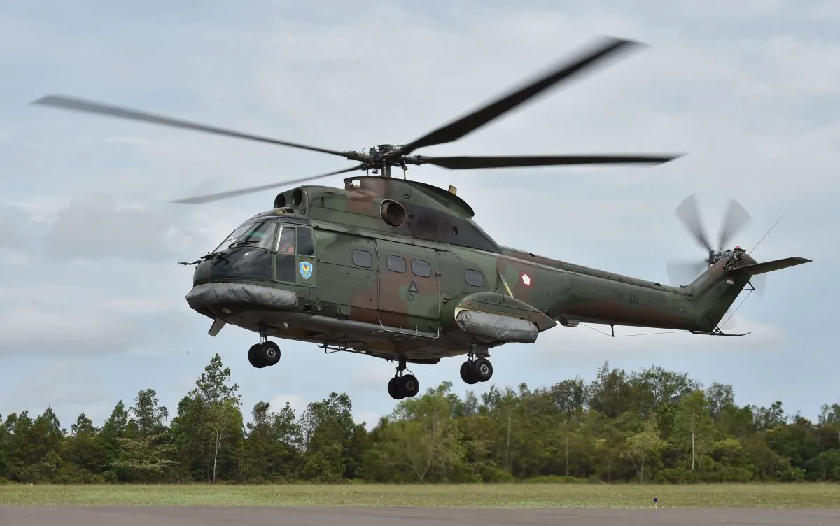 An Indonesian air force Puma helicopter takes off during search and rescue operations for the missing AirAsia flight QZ8501, in Pangkalan Bun, Central Kalimantan on Dec. 30, 2014. (Bay Ismoyo/AFP/Getty Images)