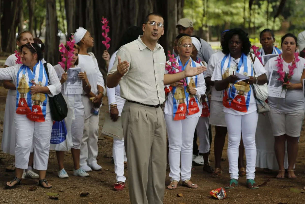 Cuban dissident Antonio Rodiles speaks during a gathering of Cuba's dissident group Ladies in White in Havana, Cuba, Sunday, Dec. 28, 2014. Cubas government has long narrowly defined the bounds of acceptable speech, accusing many dissidents of being as agents of the U.S. government or right-wing exile groups, and subjecting them to surveillance, detention and harassment. (AP Photo/Desmond Boylan)