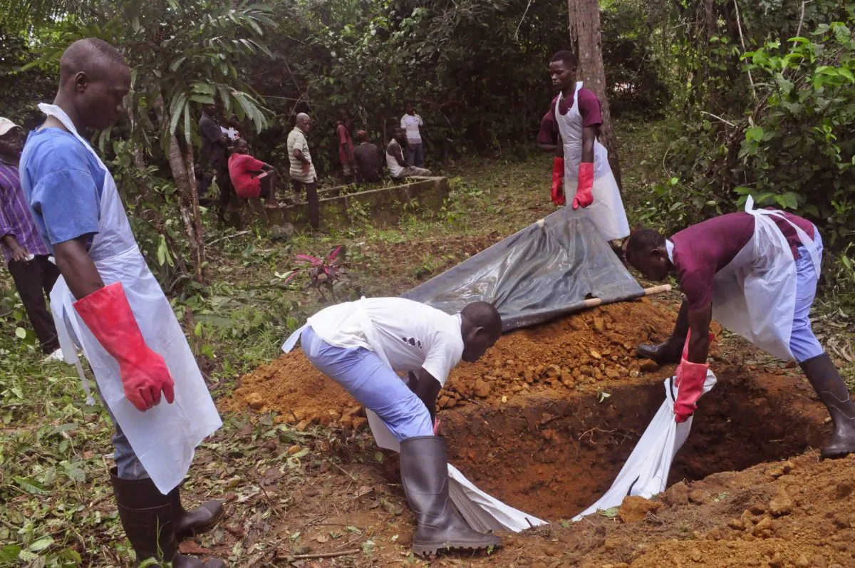 Ebola health care workers bury the body of a person suspected of dying of Ebola virus on the outskirts of Monrovia, Liberia, on Nov. 8, 2014. Ebola has killed more than 2,000 people in Sierra Leone and unsafe burials may be responsible for up to 70 percent of new infections, say experts. Officials are resorting to increasingly desperate measures to clamp down on traditional burials in Sierra Leone, where Ebola is now spreading fastest. The head of the Ebola response has even threatened to jail people who prepare the corpses of their loved ones. (AP Photo/Abbas Dulleh)