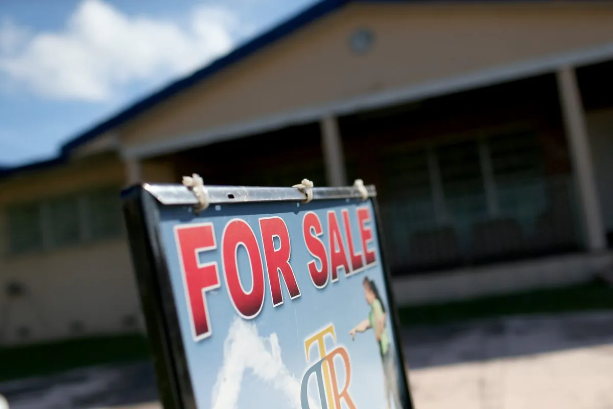 A for sale sign is seen in front of a home in Miami, Florida, on Dec. 22, 2014. (Joe Raedle/Getty Images)