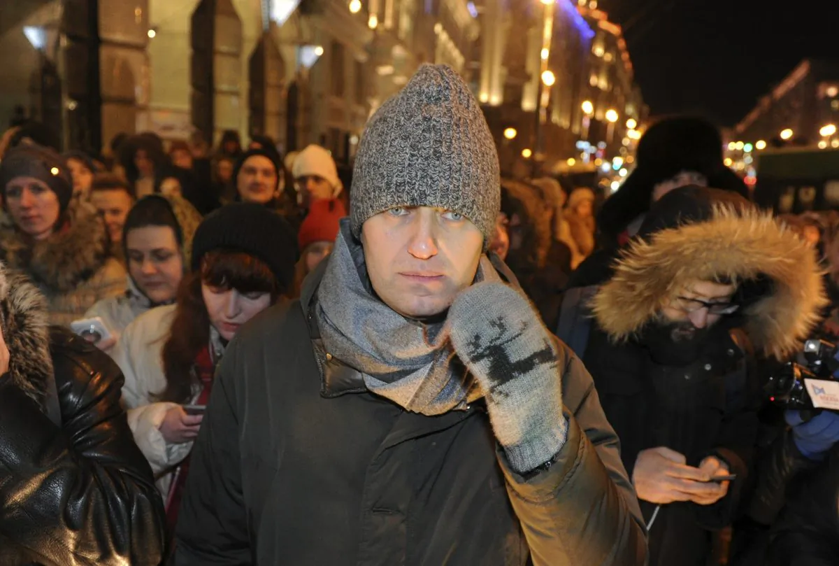 Russian opposition activist and anti-corruption crusader Alexei Navalny (C), 38, walks to attend a rally in Manezhnaya Square in Moscow, Russia, Tuesday, Dec. 30, 2014. The unsanctioned protest came hours after Alexei Navalny was found guilty of fraud and given a suspended sentence, while his brother was sent to prison. (AP Photo/Anton Belitski)