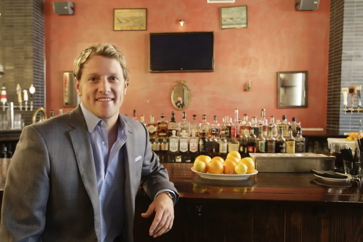 Jayson Seaver poses for a photo in New York's Harding's restaurant, of which he is a part owner, on Dec. 16, 2014. Seaver feels the wealth gap has affected his relationship with his sister. (AP Photo/Mark Lennihan)