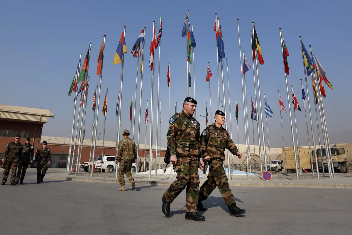 French soliders leave after a handover ceremony, at the Hamid Karzai Airport, in Kabul, Afghanistan, Wednesday, Dec. 31, 2014. (AP Photo/Rahmat Gul)