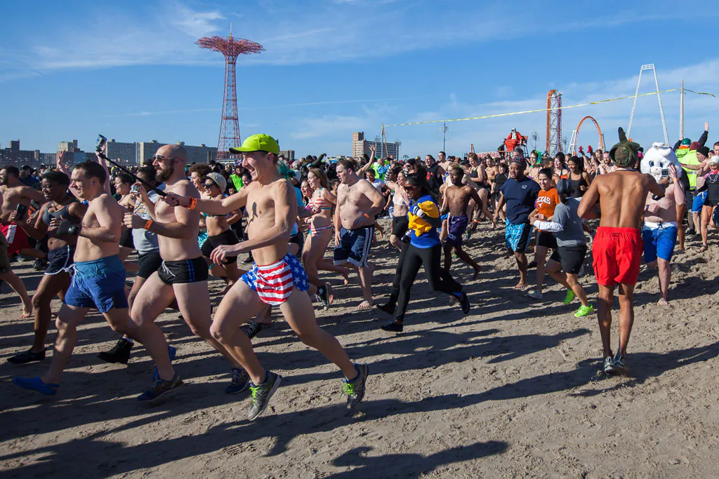 Crowds participate in the annual Polar Bear Club New Year’s Day Swim on Coney Island in Brooklyn, N.Y., on Jan. 1, 2015. The Polar Bear Club, with 150 active members, holds dips in the ocean every Sunday from November to April. (Petr Svab/Epoch Times)