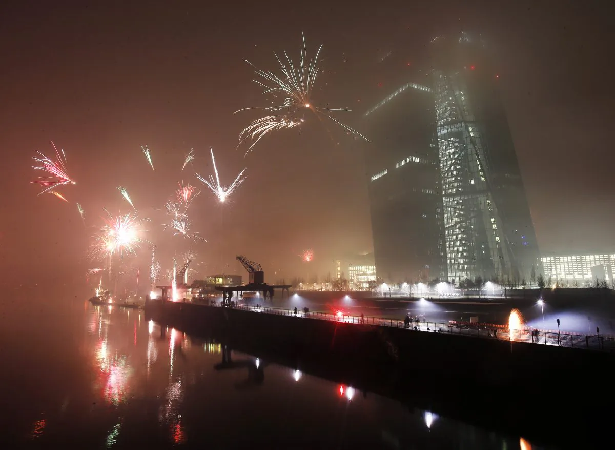 Fireworks explode during New Years celebrations near the new headquarters of the European Central Bank in Frankfurt, Germany, Thursday, Jan. 1, 2015. (AP Photo/Michael Probst)