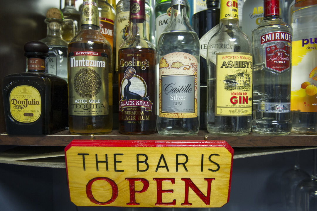Alcohol bottles, with their contents replaced with colored water, sit on a shelf in the National Institute on Alcohol Abuse and Alcoholism in Bethesda, Md., on Dec. 19, 2014. (Cliff Owen/AP Photo)