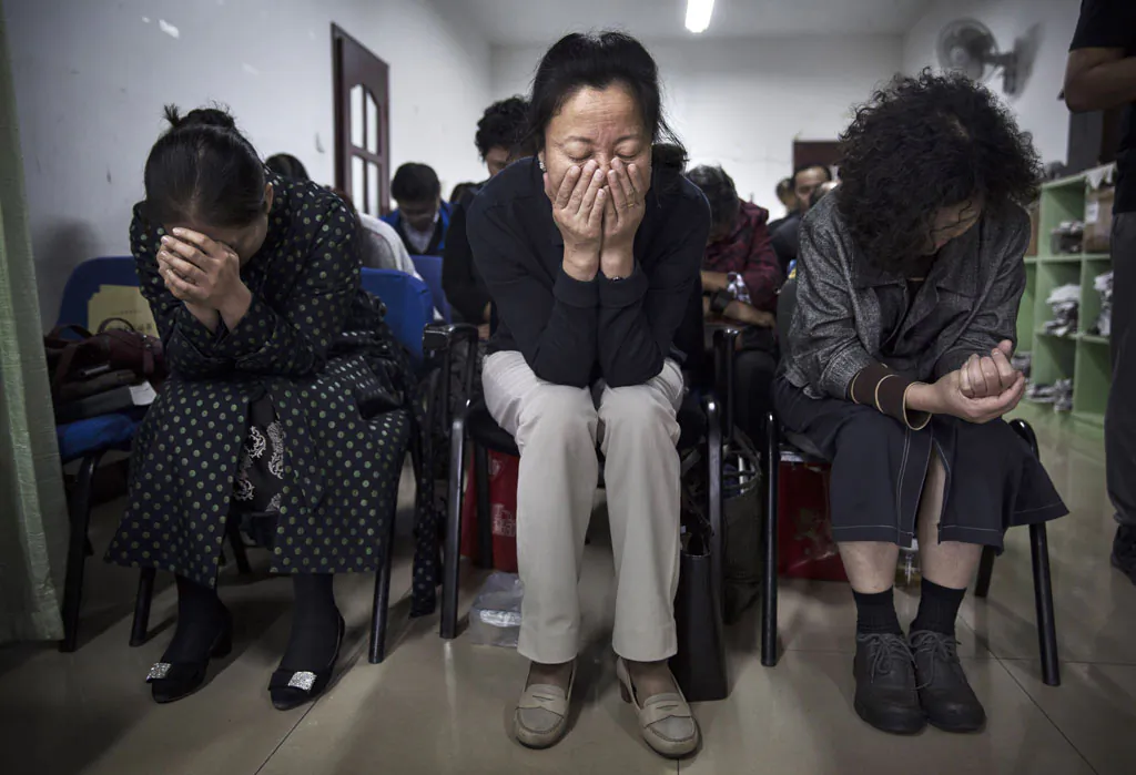 Chinese Christians pray during a service at an underground independent Protestant Church on Oct. 12, in Beijing, China. China, an officially atheist country, places a number of restrictions on Christians and allows legal practice of the faith only at state-approved churches. (Kevin Frayer/Getty Images)
