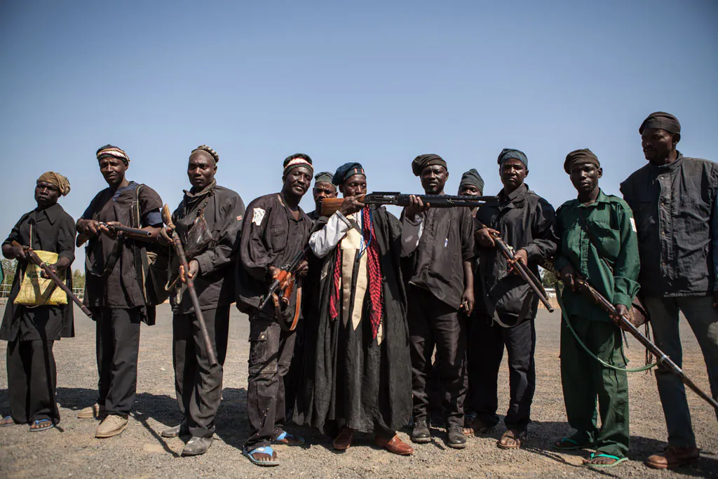 A band of hunters pose in Yola, state capital of Adamawa, on Dec. 4, 2014, after taking part in an operation against Nigerian Islamist extremist group Boko Haram. (Florian Plaucheur/AFP/Getty Images)