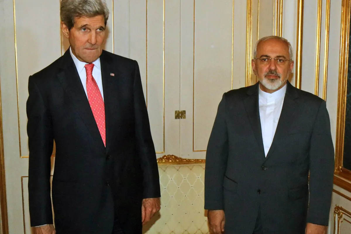 U.S. Secretary of State John Kerry and Iranian Foreign Minister Mohammad Javad Zarif, right, pose for a photograph prior to a bilateral meeting of the closed-door nuclear talks in Vienna, Austria, on Nov. 23, 2014. Diplomats say Iran and the U.S. have tentatively agreed that Tehran will ship to Russia much of the material it could use to manufacture nuclear weapons. (AP Photo/Ronald Zak, Pool-File)