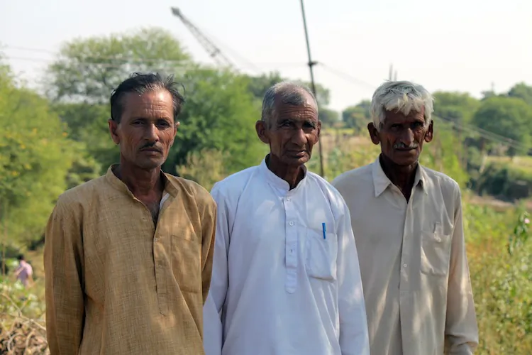 Farmers Ramesh (L), Nanak Chand (C), and Bal Krishna (R) from the Chak Changa Village in India talk about the hardships they are suffering because of a border fence that cuts through their lands in Oct. 2012. (Venus Upadhayaya/The Epoch Times)