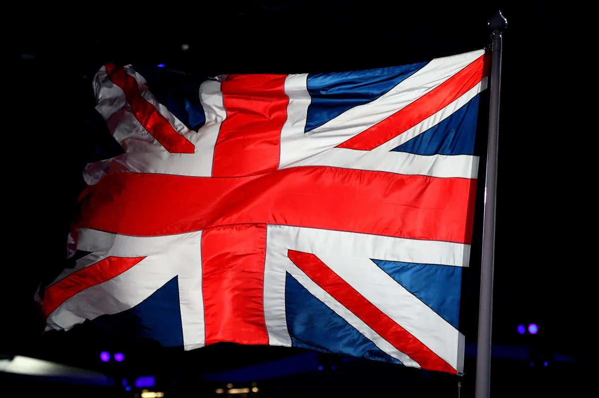 Members of the Royal Army, Navy and Airforce raise the Union Flag during the Opening Ceremony of the London 2012 Olympic Games at the Olympic Stadium on July 27, 2012 in London, England. (Ryan Pierse/Getty Images)