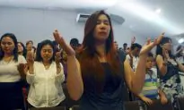 Exhausted AirAsia Victims’ Families Cry and Sing in Tiny Chapel