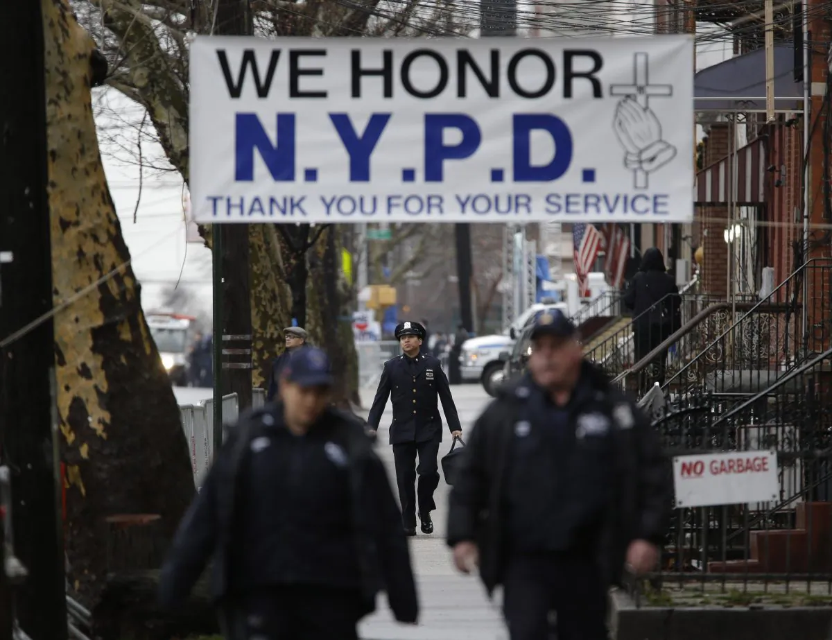 Police officers arrive to the funeral of Officer Wenjian Liu in the Brooklyn borough of New York, Sunday, Jan. 4, 2015. Liu and his partner, officer Rafael Ramos, were killed Dec. 20 as they sat in their patrol car on a Brooklyn street. The shooter, Ismaaiyl Brinsley, later killed himself. (AP Photo/Seth Wenig)