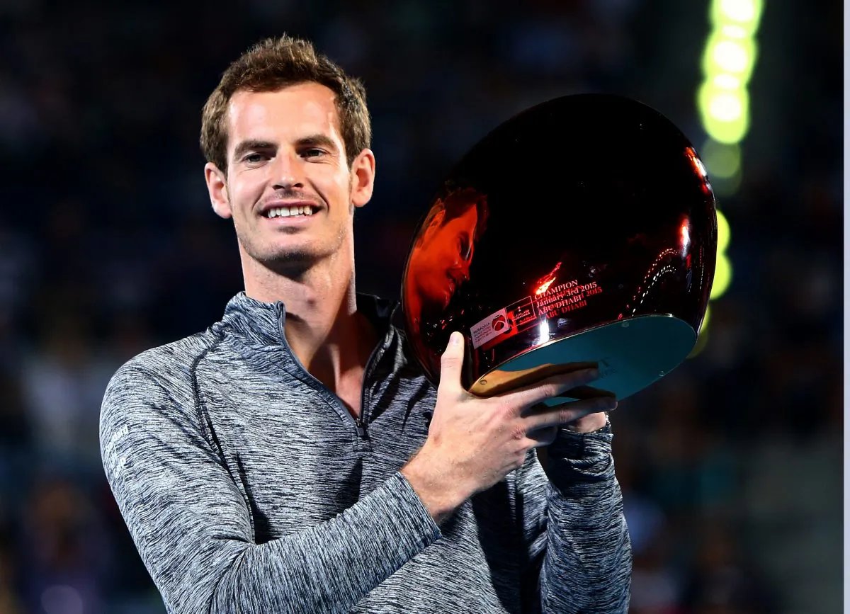 Scottish tennis player Andy Murray poses with the trophy of the Mubadala World Tennis Championship after winning the competition following the withdrawal of Serbian player Novak Djokovic from the final due to illness in Abu Dhabi, on January 3, 2015. (Marwan Naamani/AFP/Getty Images)
