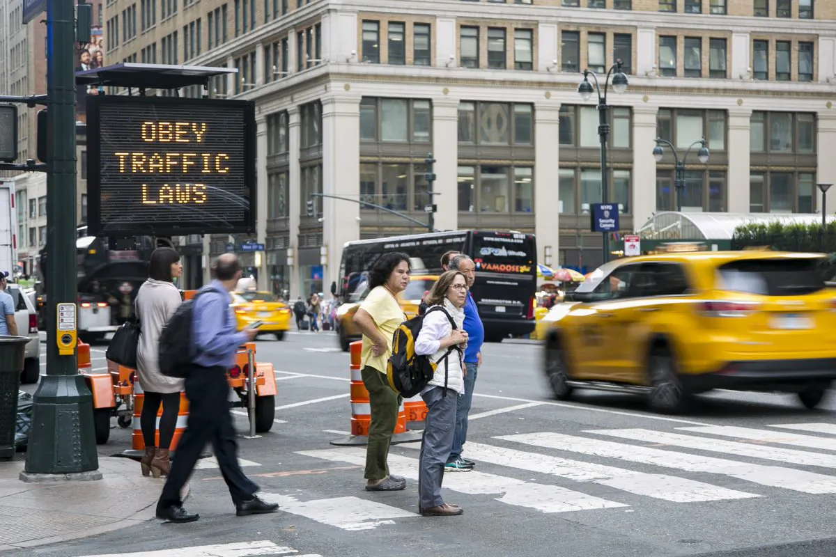 A digital board displays safety messages in front of Penn Station in Manhattan, N.Y., on Sept. 10, 2014. A law fining hit-and-run drivers in New York City has gone into effect with the New Year. (Samira Bouaou/Epoch Times)