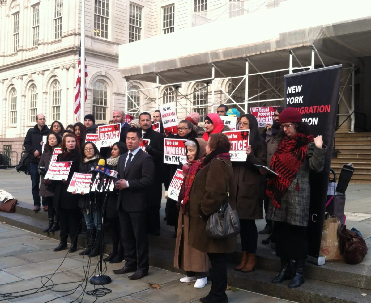 Executive director of the New York Immigration Coalition, Steven Choi (C) in Manhattan, N.Y., on Monday, January 5, 2015. He announced immigration advocates' goals for reform in the state of New York for the upcoming year. (Annie Wu/Epoch Times)