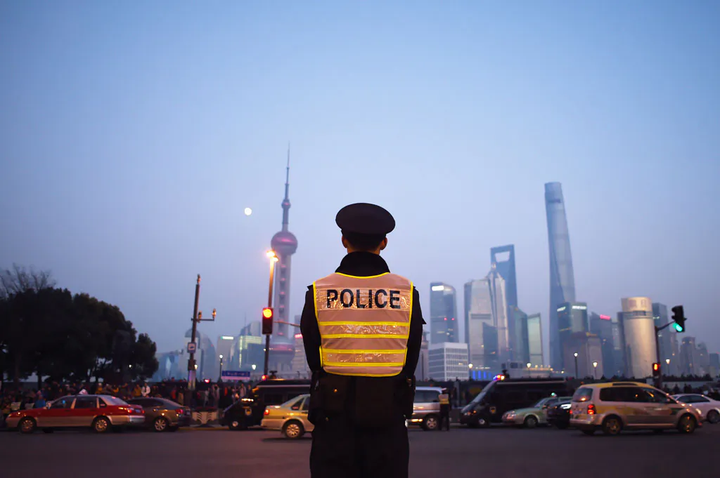 A police officer stands guard at the site of the New Year’s Eve stampede in Shanghai, on Jan. 3, 2015. Shanghai authorities have tightened censorship over the incident by blocking online criticism, summoning Internet users, and suppressing the press. (Wang Zhao/AFP/Getty Images)