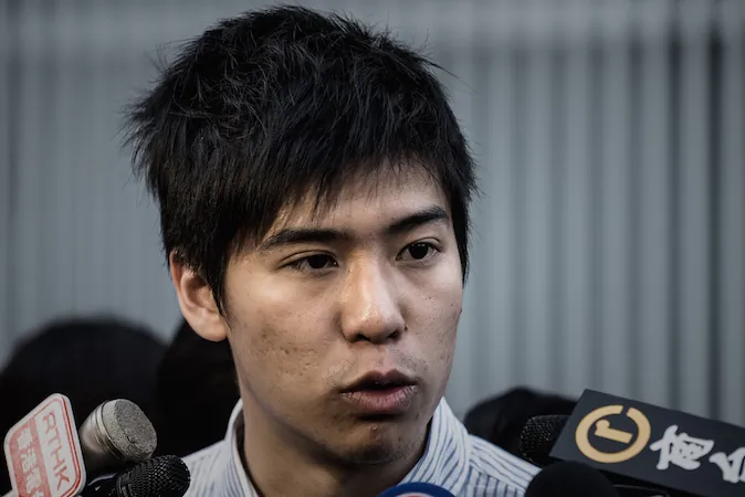 Lester Shum, one of the leaders of the Federation of Students, talks to the media outside the government building in Hong Kong on Jan. 6, 2015. (Philippe Lopez/AFP/Getty Images)