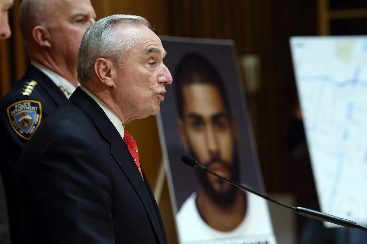 NYPD commissioner William Bratton (R) holds a news conference near a picture of suspect Jason Polanco, after two police officers were shot in the Bronx, New York, on Jan. 6, 2015. (Spencer Platt/Getty Images)