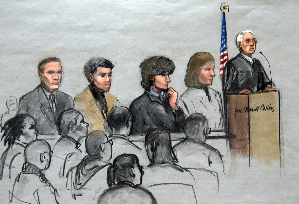 In this courtroom sketch, Boston Marathon bombing suspect Dzhokhar Tsarnaev (3rd R) is depicted with his lawyers and U.S. District Judge George O'Toole Jr. (R), as O'Toole addresses a pool of potential jurors in a jury assembly room at the federal courthouse, Tuesday, Jan. 6, 2015, in Boston. (AP Photo/Jane Flavell Collins)