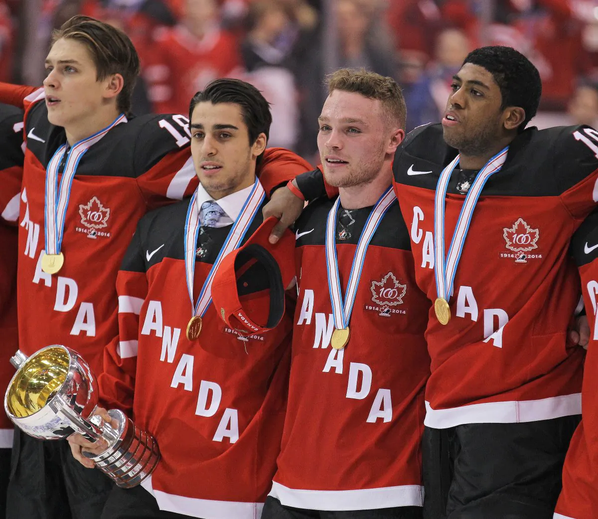 Canadian junior hockey players (L-R) Jake Virtanen, Robby Fabbri, Max Domi, and Anthony Duclair stand for “O Canada” after winning the gold medal at the Air Canada Centre in Toronto on Jan. 5, 2015. (Claus Andersen/Getty Images)