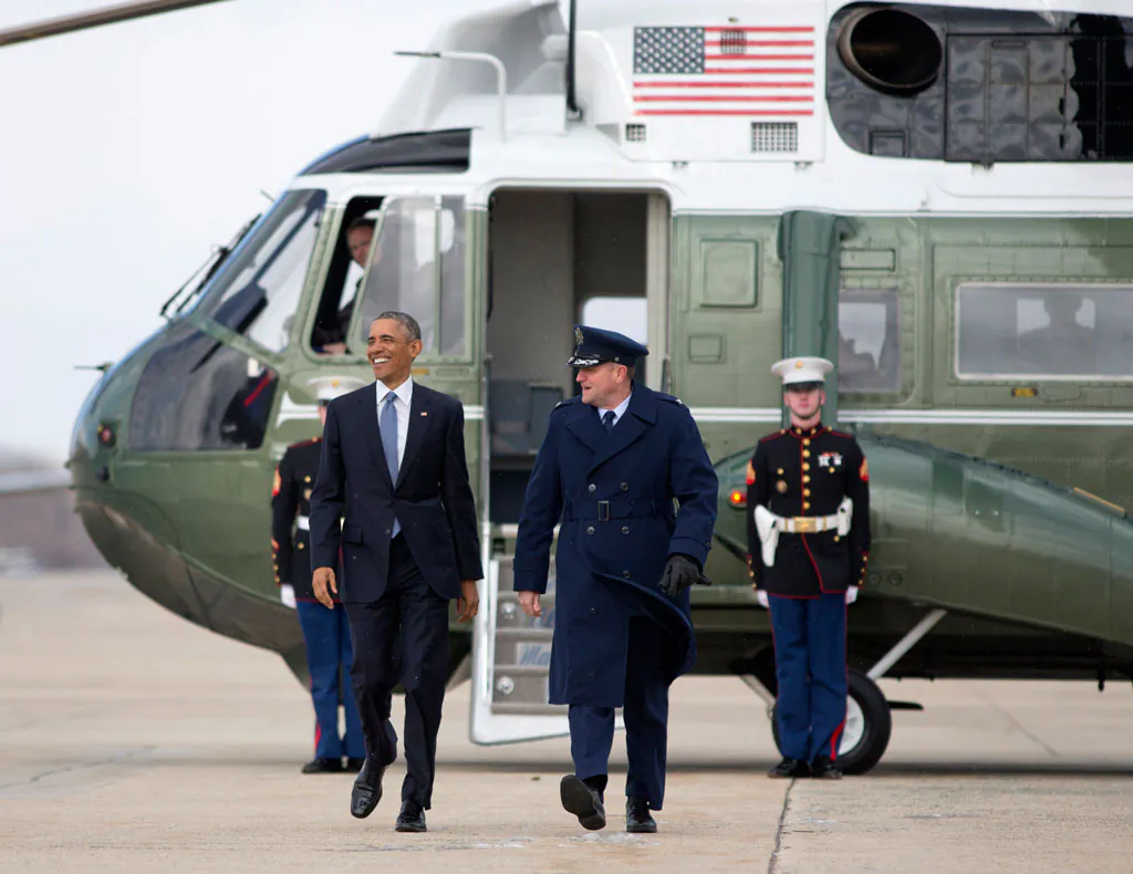 President Barack Obama walks from Marine One to board Air Force One, Wednesday, Jan. 7, 2015, at Andrews Air Force Base, Md., en route to Ford Michigan Assembly Plant in Wayne, Mich., to highlight the workers in the resurgent American automotive and manufacturing sector. (AP Photo/Carolyn Kaster)
