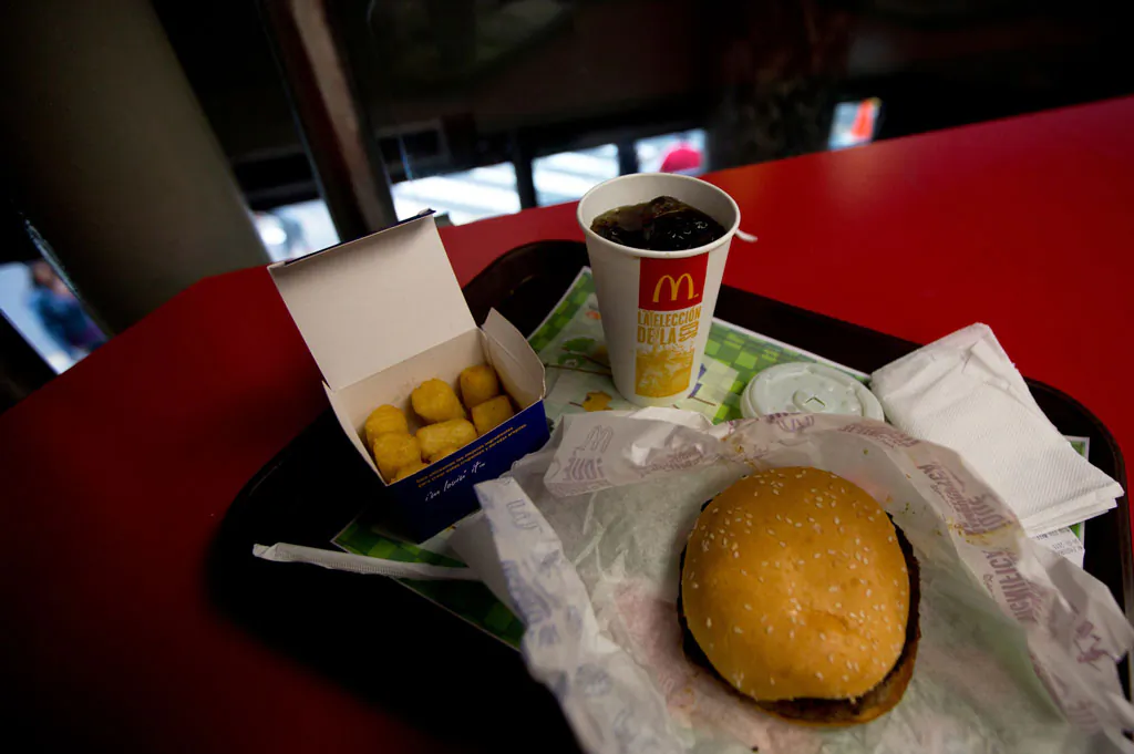 A Quarter Pounder meal is served with arepas or corn cakes at a local McDonald's, in Caracas, Venezuela, Tuesday, Jan. 6, 2015. McDonald’s franchises in Venezuela have run out of potatoes and are now serving South American alternatives like deep-fried arepas or yuca, a starchy tuberous root. The franchisers are blaming a contract dispute with West Coast dock workers for halting the export of frozen fries to the country. (AP Photo/Fernando Llano)
