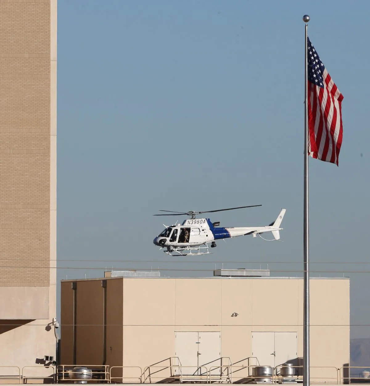 A Department of Homeland Security helicopter flies over the El Paso VA and Beaumont Army Medical Center campus during the search for a gunman in El Paso, Texas on Tuesday, Jan. 6, 2014. (AP Photo/The El Paso Times, Victor Calzada)