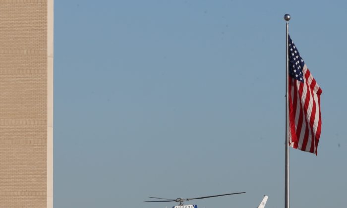 A Department of Homeland Security helicopter flies over the El Paso VA and Beaumont Army Medical Center campus during the search for a gunman in El Paso, Texas on Tuesday, Jan. 6, 2014. (AP Photo/The El Paso Times, Victor Calzada)