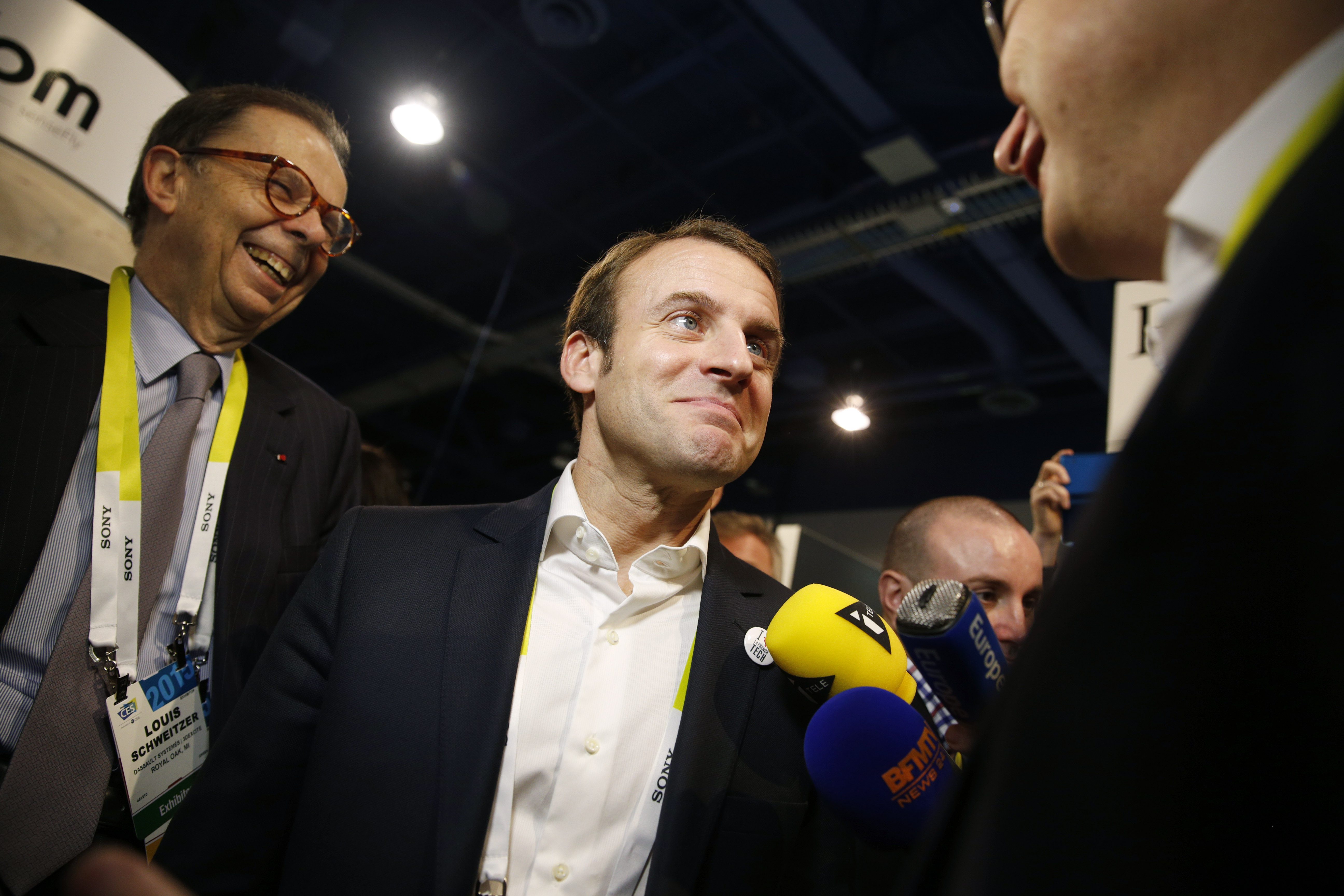 French finance minister Emmanuel Macron, center, tours the Parrot booth with Parrot CEO and founder Henri Seydoux, right, and Louis Schweitzer, Tuesday, Jan. 6, 2015, at the International CES in Las Vegas. (AP Photo/John Locher)