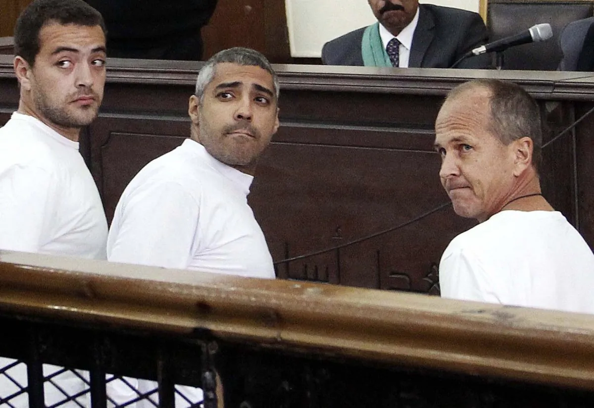 (L-R) Al-Jazeera journalists Baher Mohamed, Mohammed Fahmy, and Peter Greste appear in court during their trial on terror charges in Cairo on March 31, 2014. Fahmy’s family says they have requested his deportation and were told by a senior official the process is in its “final stages.” (AP Photo/Heba Elkholy, El Shorouk)
