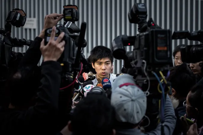 Lester Shum, one of the leaders of the Federation of Students, talks to the media outside the government building in Hong Kong on Jan. 6, 2015. (Philippe Lopez/AFP/Getty Images)