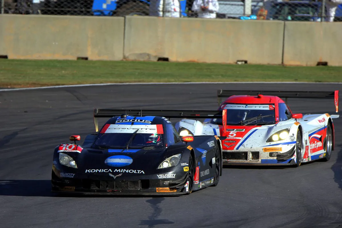 The #5 Action Express Coyote-Corvette chases #10 WTR Dallara-Corvette halfway through the 2014 Tudor United SportsCar Championship Petit Le Mans. The #10 won the race but the #5 won the season championship. Both cars will be back for 2015. (Chris Jasurek/Epoch Times)