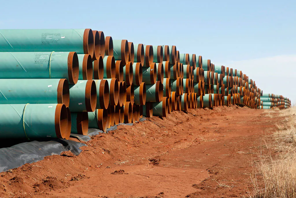 Miles of pipe ready to become part of the Keystone Pipeline are stacked in a field near Ripley, Okla., on Feb. 1, 2012. (AP Photo/Sue Ogrocki)