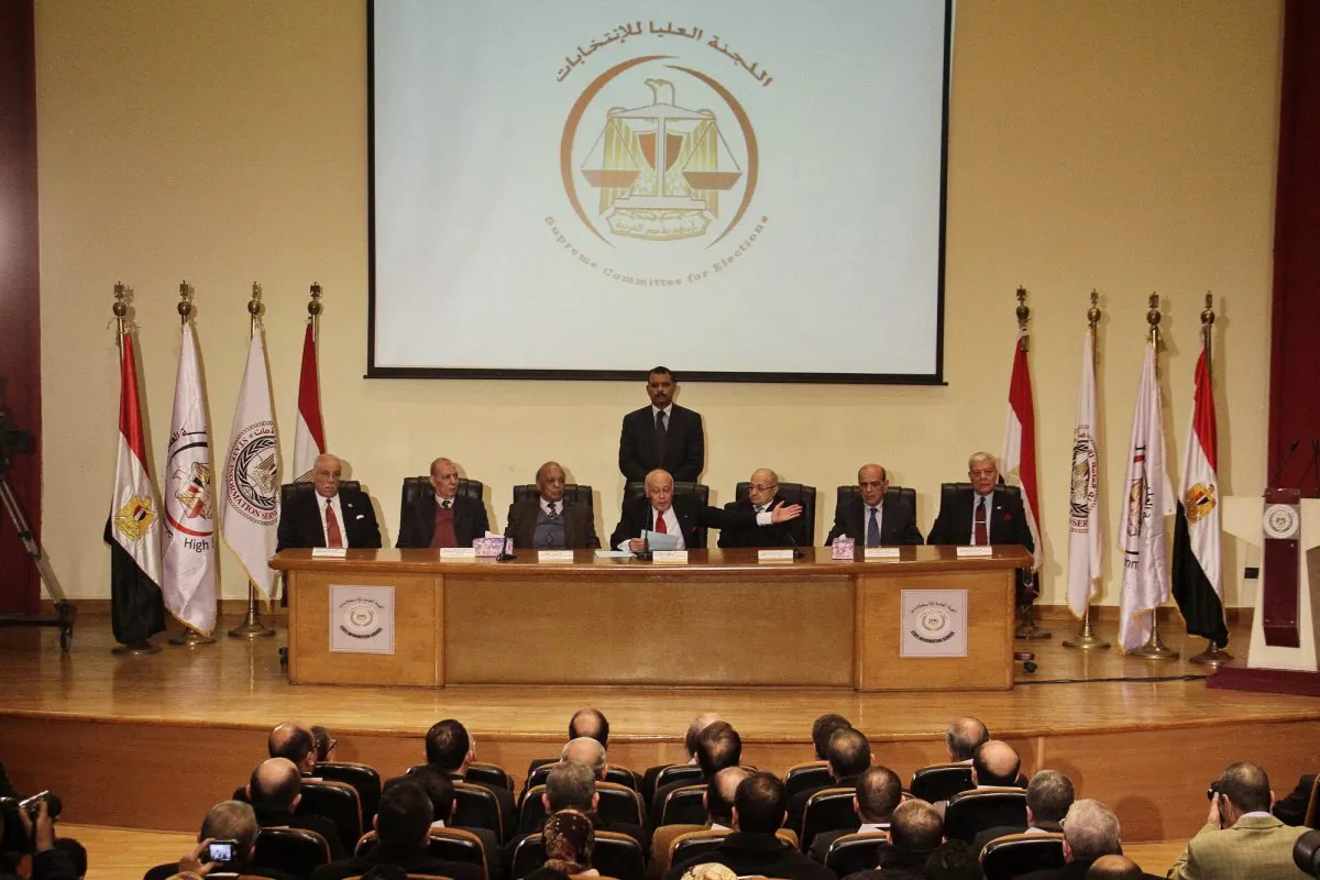 Ayman Abbas, the head of Egypt's Supreme Election Committee, center seated, speaks during a press conference in Cairo, Egypt, Thursday, Jan. 8, 2015. Egypt has scheduled long-awaited parliamentary elections. The vote will be staggered over seven weeks, starting March 21 and ending May 7, Abbas announced Thursday. (AP Photo/El Shorouk newspaper, Ahmed Abd El-Latif)