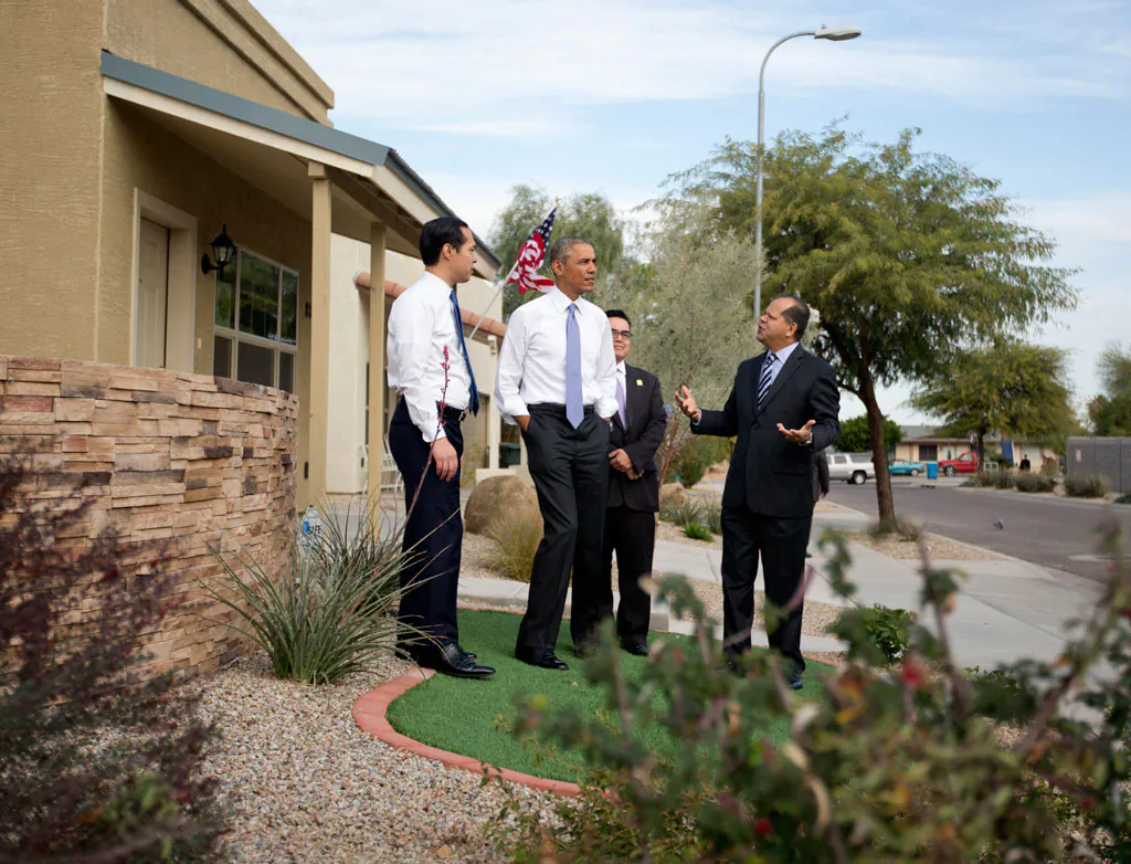 President Barack Obama, joined by Housing and Urban Development Secretary Julian Castro (L), and Chicanos Por La Causa's Edmundo Hidalgo (R), and David Adame, looks out over a housing development in Phoenix, Thursday, Jan. 8, 2015. (AP Photo/Carolyn Kaster)