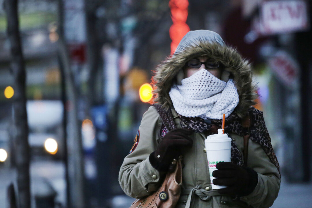 A woman carries a beverage in a plastic foam cup in New York City on Thursday, Jan. 8, 2015. Foam cups, plates, trays, and packaging peanuts will be banned in New York City beginning in July. (AP Photo/Mark Lennihan)
