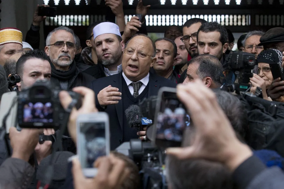 Grand Mosque rector Dalil Boubakeur (C) delivers a statement to members of the media following Friday prayers, Paris, Friday, Jan. 9, 2015. (AP Photo/Michel Euler)