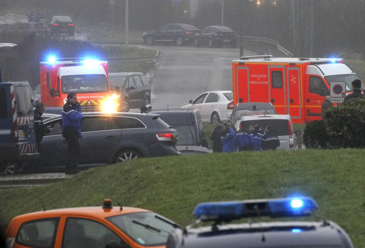 Ambulances arrive in Dammartin-en-Goele, northeast Paris, as part of an operation to seize two heavily armed suspects, Friday, Jan. 9, 2015. French security forces swarmed a small industrial town northeast of Paris Friday in an operation to capture a pair of heavily armed suspects in the deadly storming of a satirical newspaper. Shots were fired as the brothers stole a car in the early morning hours, said a French security official, who could not immediately confirm reports of hostages taken or deaths later in the day in the town of Dammartin-en-Goele, about 40 kilometers (25 miles) northeast of Paris. (AP Photo/Michel Spingler)