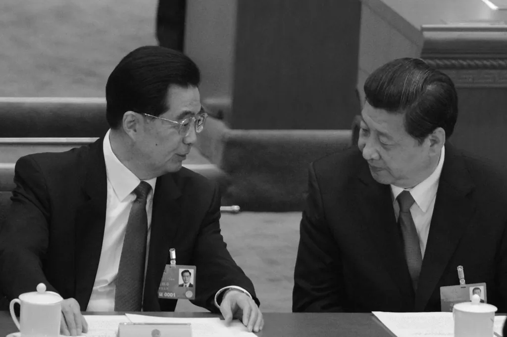 Former Chinese Communist Party leader Hu Jintao talks to newly-elected Party chief Xi Jinping at the closing session of the National People's Congress (NPC) in Beijing on March 17, 2013. Hu is said to have complained about the former communist leader Jiang Zemin. (Goh Chai Hin/AFP/Getty Images)