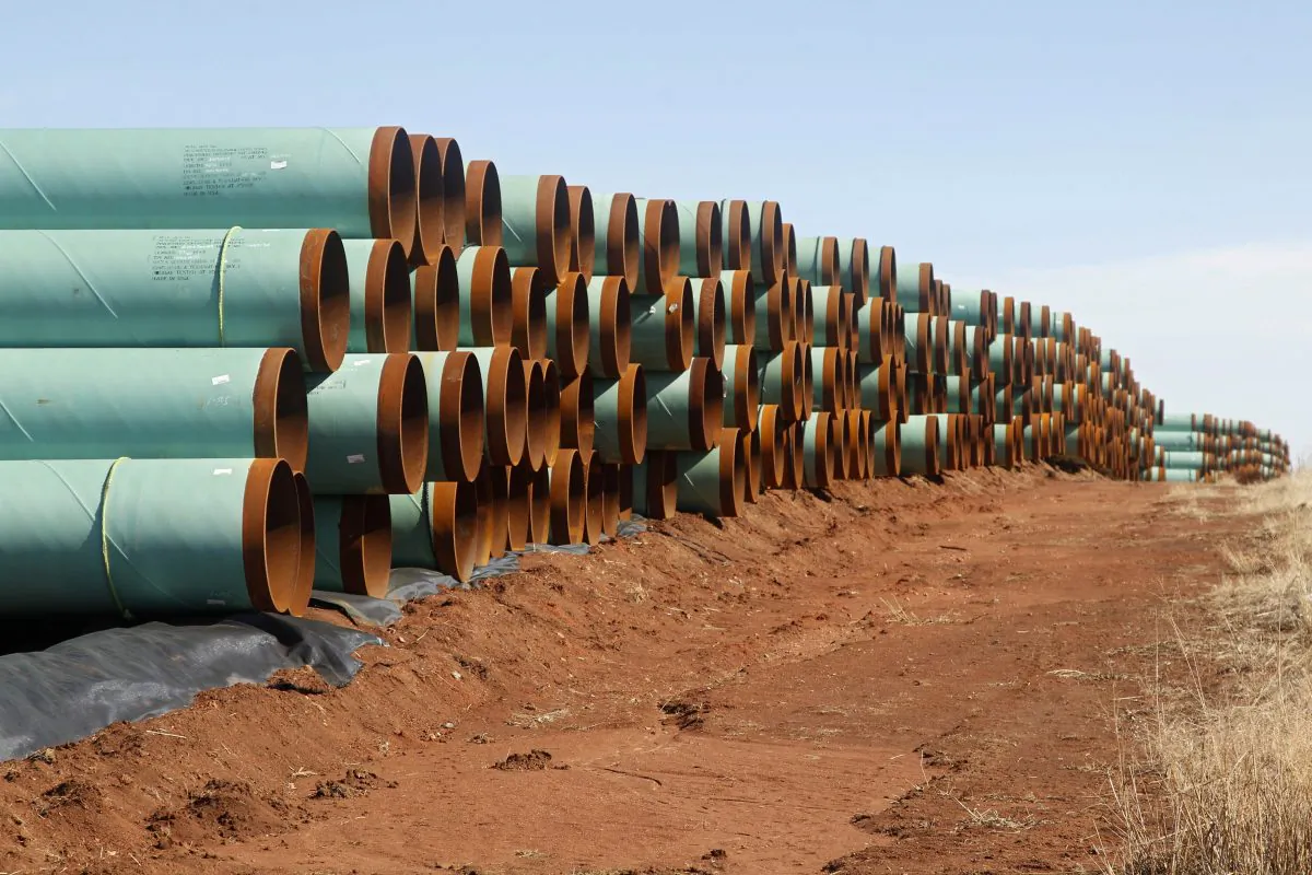 Miles of pipe ready to become part of the Keystone Pipeline are stacked in a field near Ripley, Okla., on Feb. 1, 2012. (AP Photo/Sue Ogrocki)