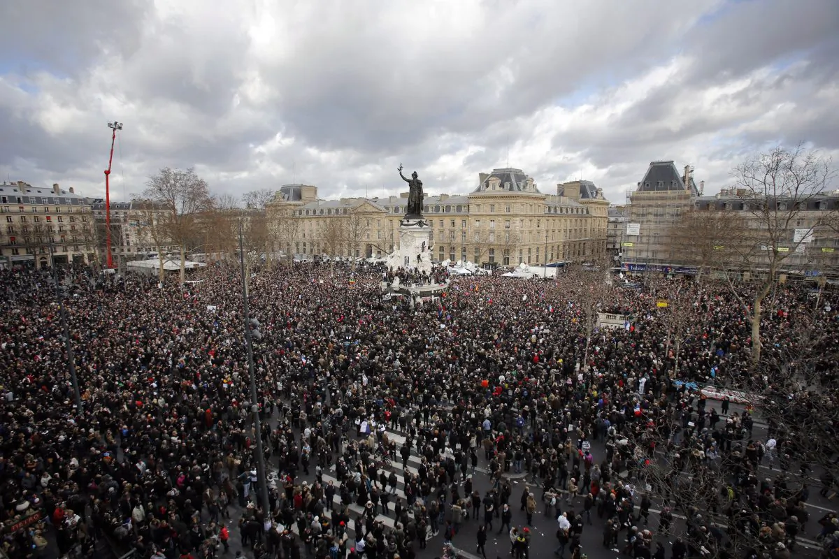 A crowd gather in Republique square before the demonstration, in Paris, France, Sunday, Jan. 11, 2015. A rally of defiance and sorrow, protected by an unparalleled level of security, on Sunday will honor the 17 victims of three days of bloodshed in Paris that left France on alert for more violence. (AP Photo/Laurent Cipriani)