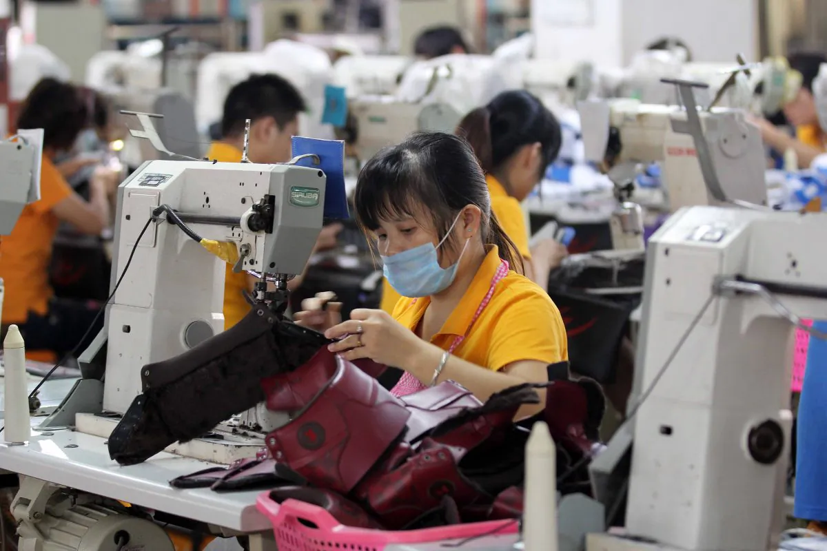 Laborers work in a shoe factory in Jinjiang, south China's Fujian province on Sept. 17, 2013.  (STR/AFP/Getty Images)