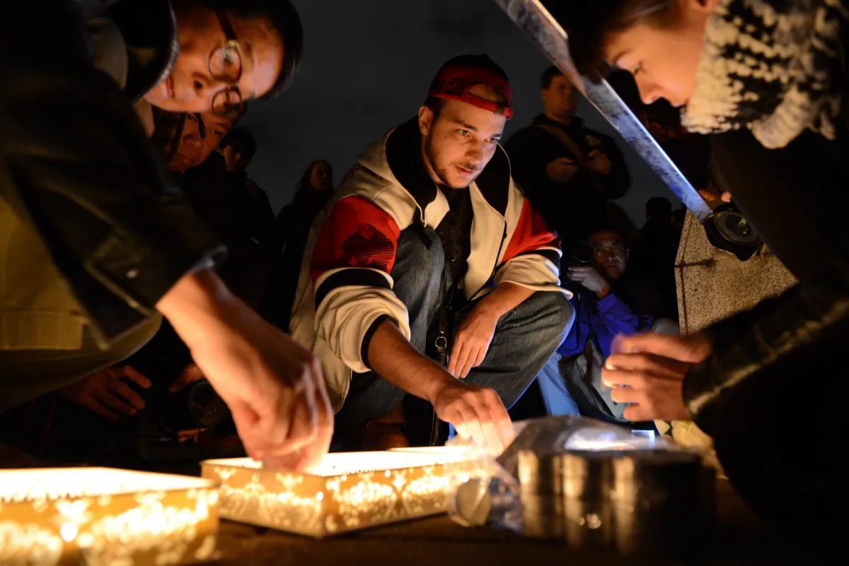 French nationals attend a vigil in solidarity with the victims of the shooting at the Paris office of the satirical newspaper Charlie Hebdo in front of the Chiang Kai-shek Memorial Hall in Taipei on Jan. 9, 2015. As thousands converge in France for an anti-terror rally, support is shown around the world. (Sam Yeh/AFP/Getty Images)