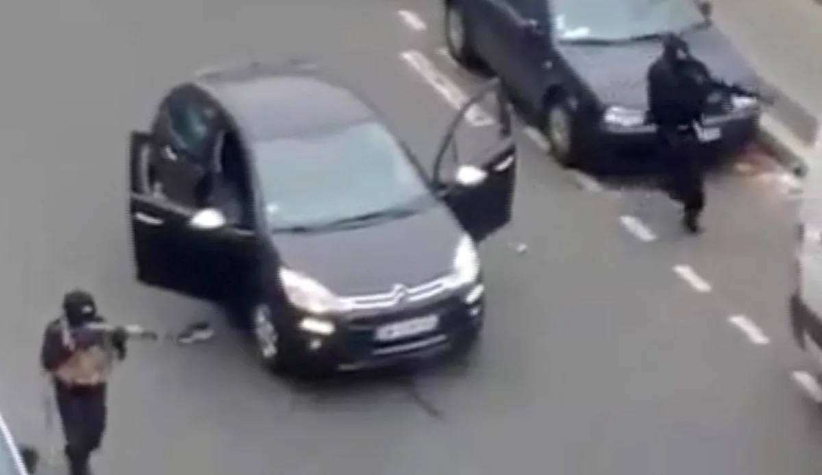 Masked gunman fire their weapons outside the French satirical newspaper Charlie Hebdo's office in Paris on Jan. 7, 2015. Though it is impossible to gauge in any tangible way the effect the deadly attack on a Paris newspaper will have on recruitment by extremist groups - and there is no evidence so far that it is mobilizing large numbers of would-be jihadis - experts believe the perceived professionalism of the brothers' assault and their subsequent showdown with police could rally more supporters to militant ranks. (AP Photo)