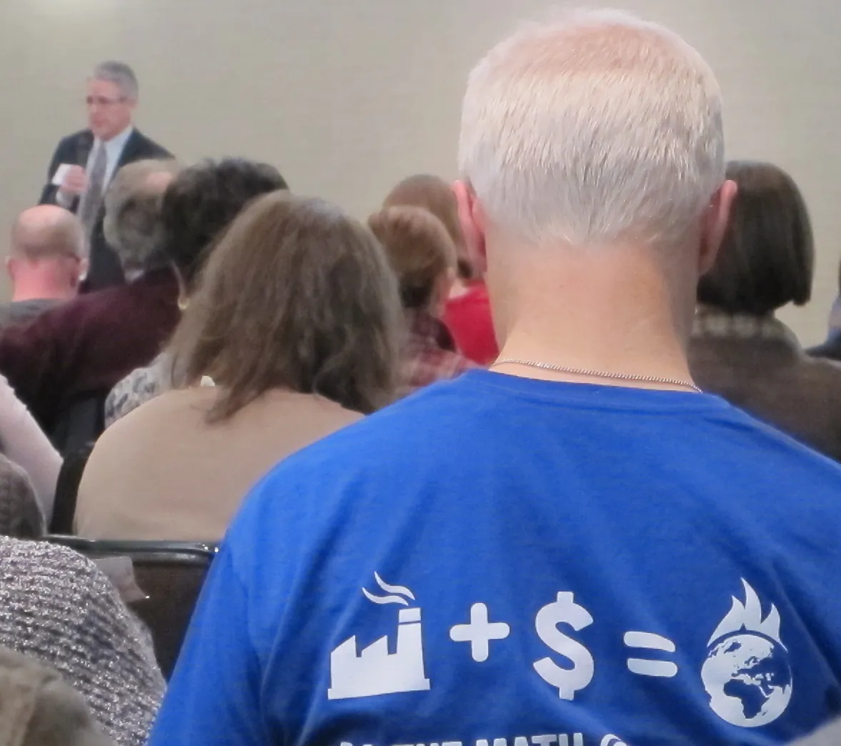 An environmentalist concerned about global warming wears a statement t-shirt at a public hearing on a proposed offshore terminal for imports of liquefied natural gas in Eatontown, N.J., on Jan. 8, 2015. Liberty Natural Gas wants to build the facility off the coasts of New York and New Jersey. (AP Photo/Wayne Parry)