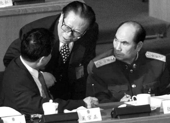 Chinese Communist Party head Jiang Zemin (C) chats with Shandong Communist Party Secretary Wu Guanzheng (L) and Vice Chairman of the Central Military Commission (CMC) General Zhang Wannian in Beijing, March 6, 2000. At a Party meeting in 2002, Zhang would propose that Jiang be retained as head of the CMC for two years after his scheduled retirement. (Goh Chai Hin/AFP/Getty Images)