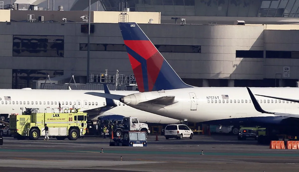 A Delta Air Lines jet, right, sits parked after making an emergency landing at Los Angeles International Airport, Tuesday, Jan. 13, 2015. The Boeing 757 experienced a mechanical problem soon after takeoff on a flight from Los Angeles to Minneapolis and had to circle off the Southern California coast for about an hour to burn fuel before landing safely back at the airport. (AP Photo/Nick Ut)